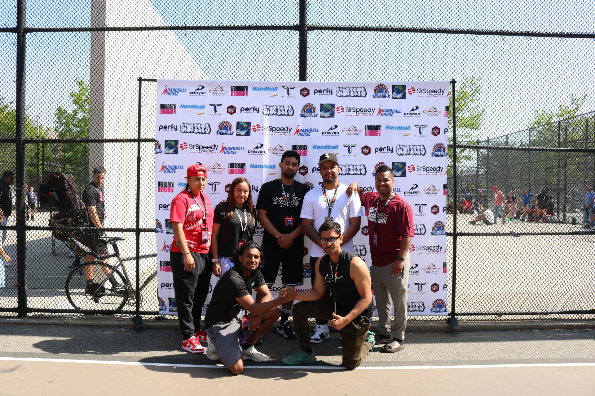 MegaWall staff and volunteers in front of the season backdrop